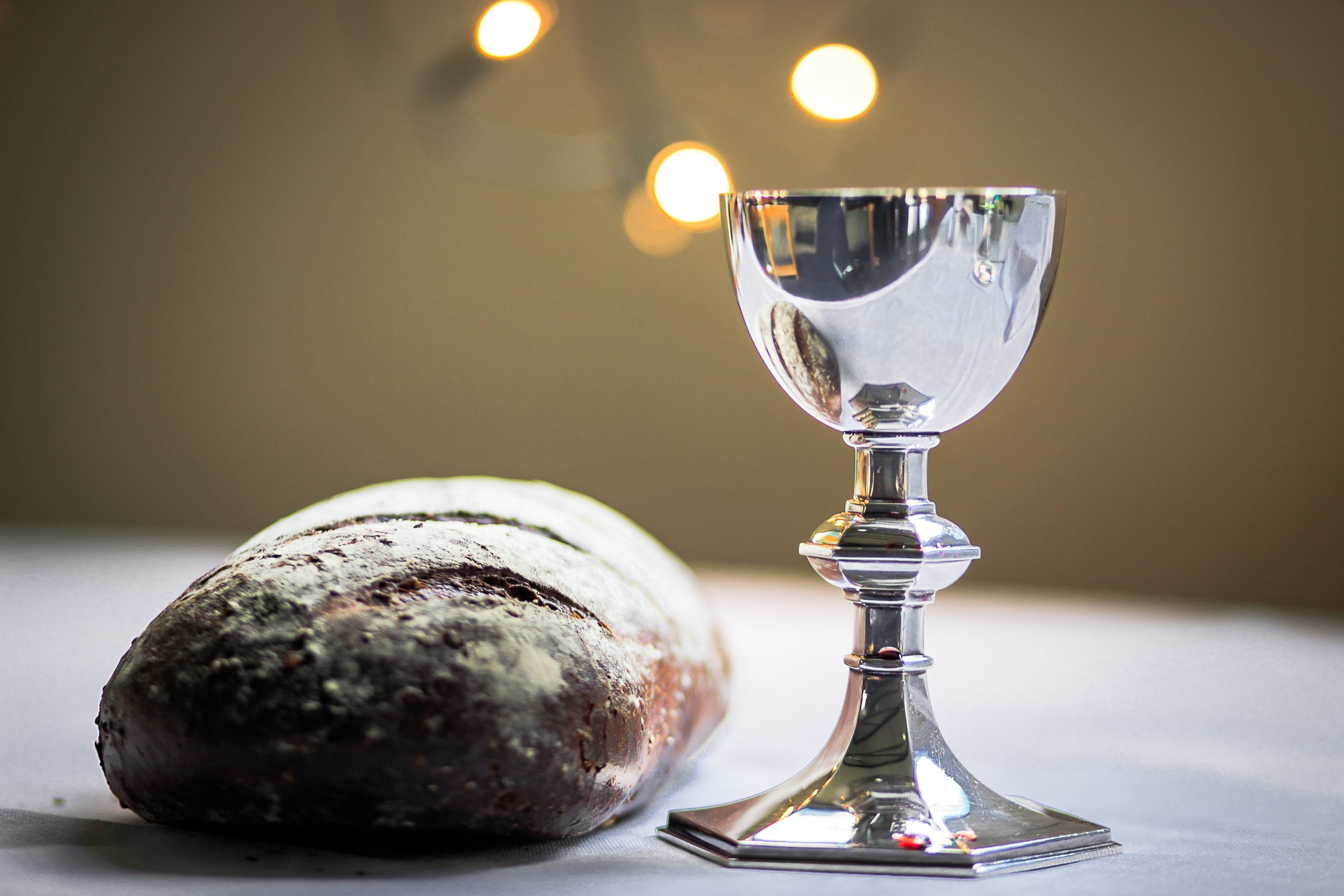 gray stainless steel chalice and bread bun